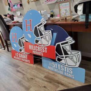 Oversized 28-inch contour-shaped football helmet yard signs made of weather-proof corrugated plastic with custom team themes and personalization